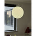 Ceiling pendant light hanging beside a window, the buttermilk BO-HA Kaja swirl glass globe unlit.