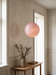 Entryway pendant light above an oak console with dried branches – the pink BO-HA Kaja glass globe.