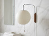 Gunnar Wall Sconce – Ball shade, chrome arc arm, slim walnut bracket, marble bathroom spa setting