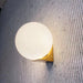 Solja – modern glass orb LED bedside wall sconce – gold finish with frosted glass globe