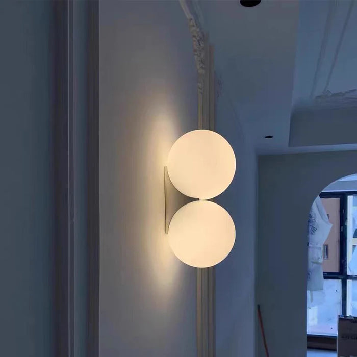 Solja – modern glass orb LED wall sconce in a Scandinavian hallway – gold double head