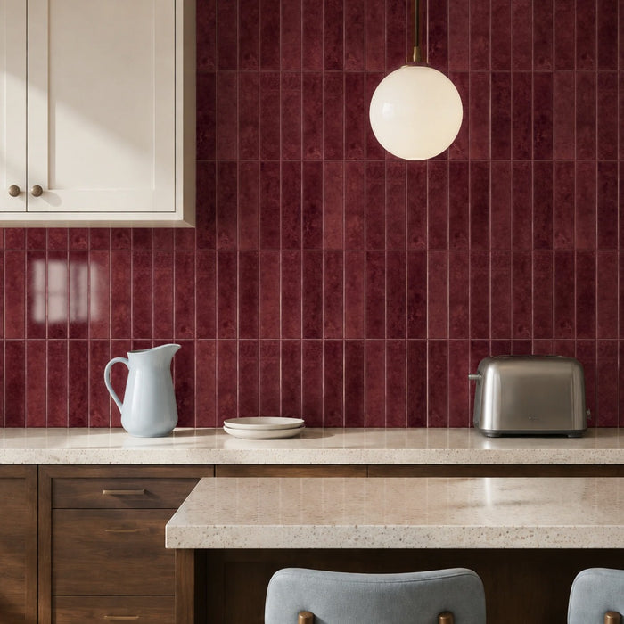 Ebba peel and stick backsplash in deep burgundy behind cream cabinets with a globe pendant light